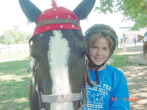 Macy Stockdale at the National Trails horse camp during Grand week in Englewood. Horse ranch offered daily trail riding or week long horse school. Students learned to care for horses during the week. Most importantly, Macy learned to clean up after a horse. The horse camp was less than five miles from the old home grounds.